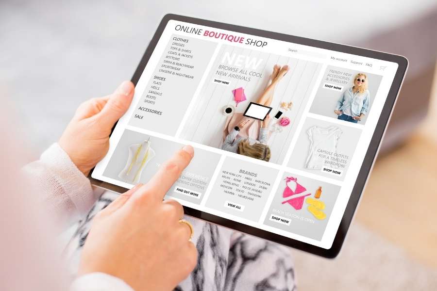 Online fashion marketing interface showing boutique shop website with clothing categories and promotional content